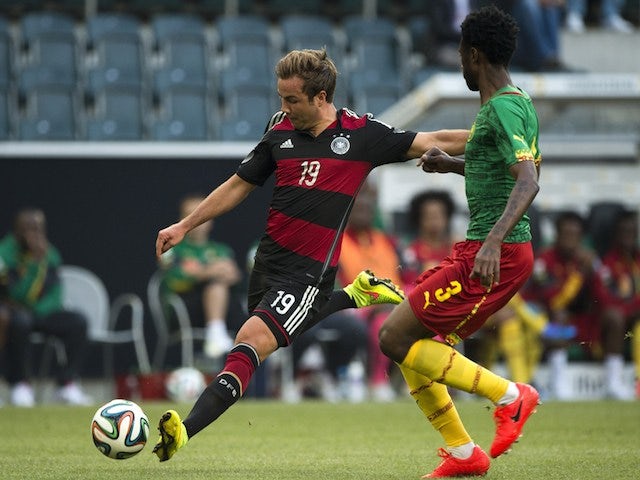 Germany's midfielder Mario Gotze (L) and Cameroon's defender Nicolas Nkoulou vie for the ball during the friendly football match on June 1, 2014