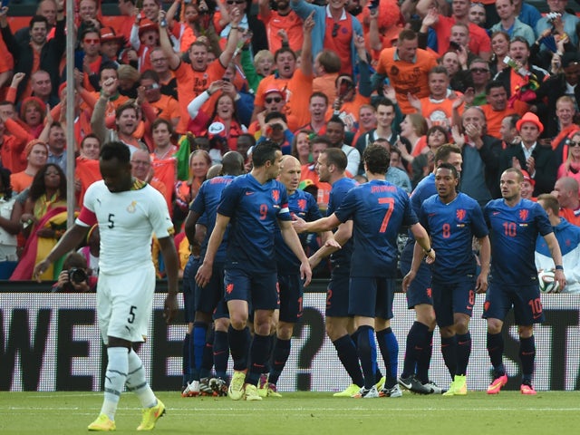 Netherlands' forward Robin van Persie is congratulated by teammates after scoring a goal during the international friendly football match Netherlands against Ghana on May 31, 2014