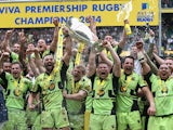 Northampton Saints team captain Dyland Hartley (R) and match captain Tom Wood raise the trophy after their victory during the Aviva Premiership Final between Saracens and Northampton Saints at Twickenham Stadium on May 31, 2014
