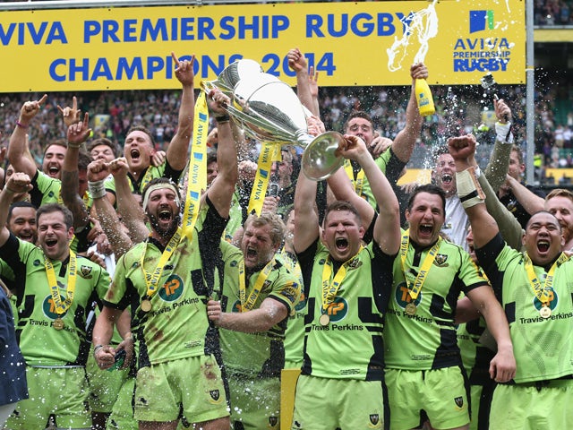 Northampton Saints team captain Dyland Hartley (R) and match captain Tom Wood raise the trophy after their victory during the Aviva Premiership Final between Saracens and Northampton Saints at Twickenham Stadium on May 31, 2014