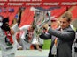 Swansea City's manager Brendan Rodgers celebrates with the trophy after his team beat Reading during the 2011 Championship play-off final football match at Wembley Stadium in London on May 30, 2011
