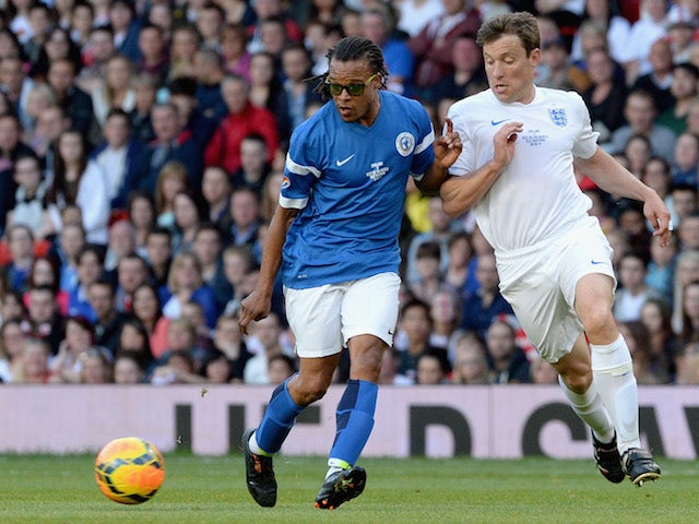 Edgar Davids of the Rest of the World is closed down by Ben Shephard of England during Soccer Aid 2014 at Old Trafford on June 8, 2014 