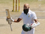 Hashim Amla of South Africa celebrates reaching 100 runs during day four of the second Test against Australia in Port Elizabeth on February 23, 2014