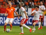  Arjen Robben of Netherlands runs on goal followed by Daniel Gabbidon and Joe Allen of Wales during the International Friendly match between The Netherlands and Wales at Amsterdam Arena on June 4, 2014