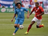 Honduras' midfielder Roger Espinoza (L) vies for the ball with England's defender Glen Johnson before the friendly game on June 7, 2014