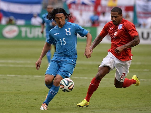 Honduras' midfielder Roger Espinoza (L) vies for the ball with England's defender Glen Johnson before the friendly game on June 7, 2014