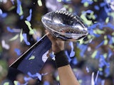 Quarterback Russell Wilson of the Seattle Seahawks holds the Vince Lombardi Trophy following victory over the Denver Broncos on February 2, 2014