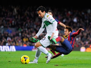  Neymar of FC Barcelona is brought down by Sergio Mantecon of Elche FC during the La Liga match between FC Barcelona and Elche FC at Camp Nou on January 5, 2014