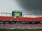 Lightning strikes behind the scoreboard as the match is delayed due to inclement weather during the International Friendly match between England and Honduras on June 7, 2014