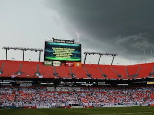 Lightning strikes behind the scoreboard as the match is delayed due to inclement weather during the International Friendly match between England and Honduras on June 7, 2014