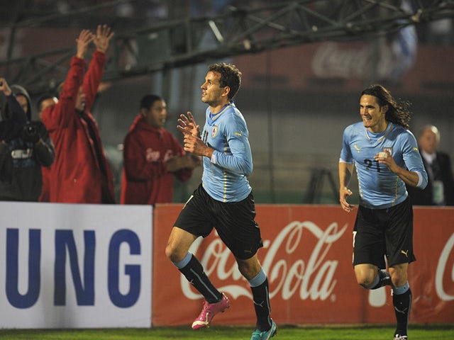 Uruguay's forward Christian Stuani celebrates with teammate Edison Cavani after scoring against Slovenia during a friendly football match on June 4, 2014
