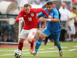 Wayne Rooney of England holds off Emilio Izaguirre of Honduras in the first half during the International Friendly match on June 7, 2014