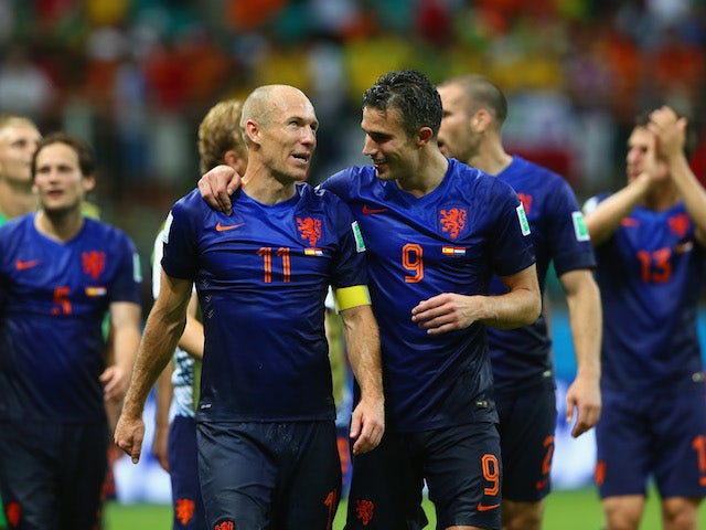 Arjen Robben (L) and Robin van Persie of the Netherlands walk off the field after scoring two goals each and defeating Spain 5-1 during the 2014 FIFA World Cup on June 13, 2014