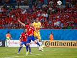  Tim Cahill of Australia goes up for a header against Gary Medel of Chile and scores a goal during the 2014 FIFA World Cup Brazil Group B match between Chile and Australia at Arena Pantanal on June 13, 2014 
