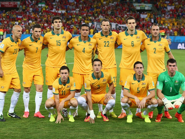 Australia line up for a team photo before the 2014 FIFA World Cup Brazil Group B match between Chile and Australia at Arena Pantanal on June 13, 2014