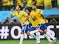 Neymar of Brazil celebrates scoring a first half goal with Marcelo and Hulk during the 2014 FIFA World Cup Brazil Group A match between Brazil and Croatia at Arena de Sao Paulo on June 12, 2014