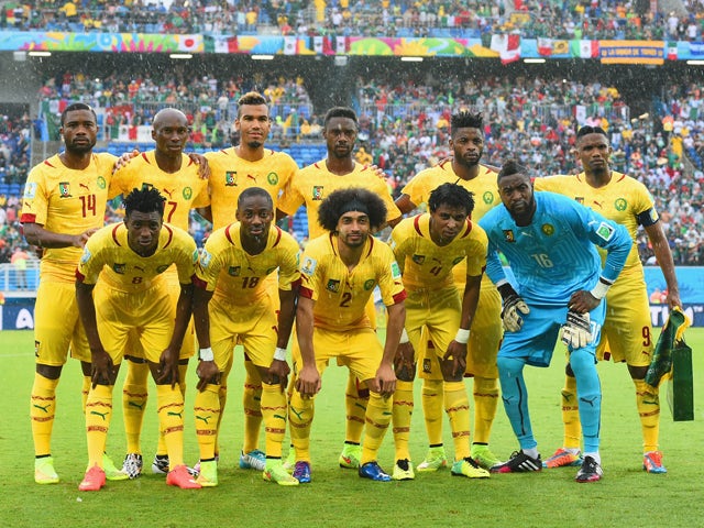 Cameroon players pose for a team photo before the 2014 FIFA World Cup Brazil Group A match between Mexico and Cameroon at Estadio das Dunas on June 13, 2014