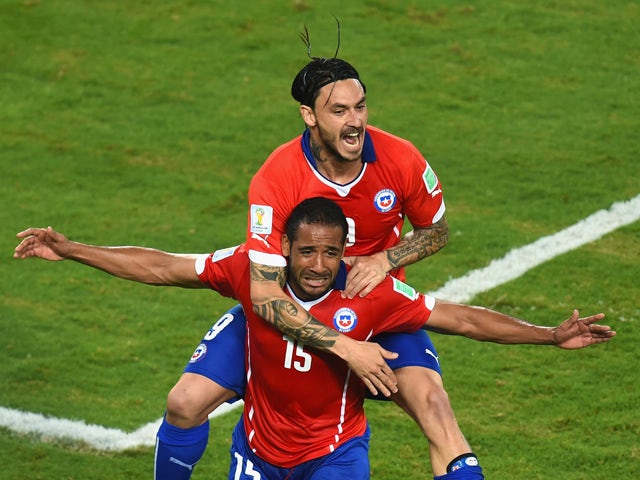  Jean Beausejour of Chile celebrates scoring his teams third goal with Mauricio Pinilla during the 2014 FIFA World Cup Brazil Group B match between Chile and Australia at Arena Pantanal on June 13, 2014