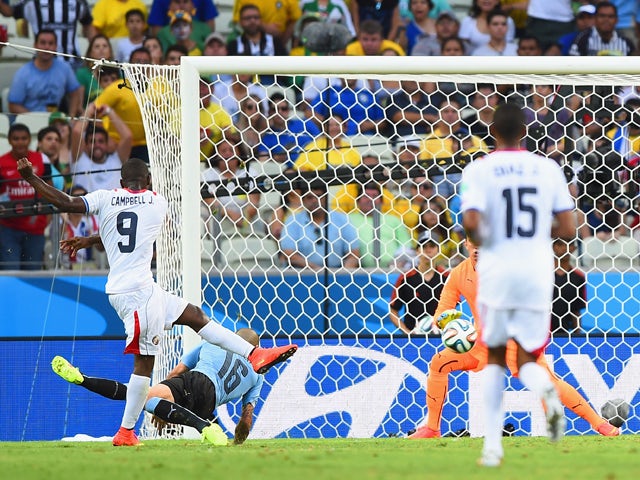 Joel Campbell of Costa Rica shoots and scores his team's first goal during the 2014 FIFA World Cup Brazil Group D match between Uruguay and Costa Rica at Castelao on June 14, 2014