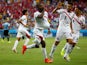 Joel Campbell of Costa Rica celebrates scoring his team's first goal with the ball under his jersey as teammates Oscar Duarte and Michael Umana run on during the 2014 FIFA World Cup Brazil Group D match between Uruguay and Costa Rica at Castelao on June 1