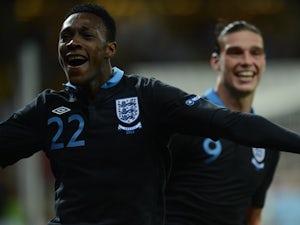 English forward Dany Welbeck celebrates with Andy Carroll after scoring a goal during the Euro 2012 championships football match Sweden vs England on June 15, 2012