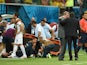 England manager Roy Hodgson speaks to head coach Cesare Prandelli of Italy as England trainer Gary Lewin lies on the ground being treated for an injury during the 2014 FIFA World Cup Brazil Group D match between England and Italy at Arena Amazonia on June