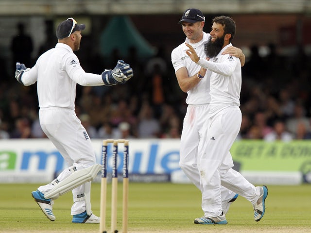 Englands Moeen Ali celebrates taking the wicket of Sri Lankas Kumar Sangakkara for 147 runs with Englands James Anderson during the third day of the first cricket Test match between England and Sri Lanka at Lord's cricket ground in London on June 14, 201