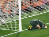 England's goalkeeper Robert Green reacts after missing a goal during their Group C first round 2010 World Cup football match on June 12, 2010