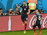 France's forward Karim Benzema celebrates after scoring his teams third goal with midfielder Mathieu Valbuena, during a Group E football match between France and Honduras at the Beira-Rio Stadium in Porto Alegre during the 2014 FIFA World Cup on June 15, 