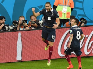 France's forward Karim Benzema celebrates after scoring his teams third goal with midfielder Mathieu Valbuena, during a Group E football match between France and Honduras at the Beira-Rio Stadium in Porto Alegre during the 2014 FIFA World Cup on June 15, 