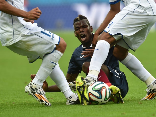 France's midfielder Paul Pogba is tackled by Honduras' midfielder Wilson Palacios (R) during a Group E football match between France and Honduras at the Beira-Rio Stadium in Porto Alegre during the 2014 FIFA World Cup on June 15, 2014