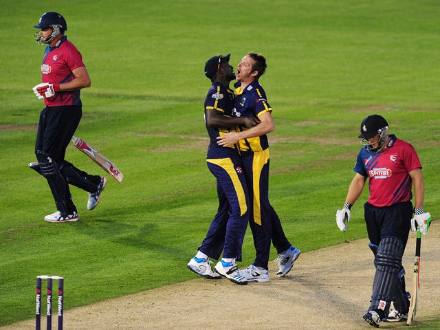 Michael Hogan of Glamorgan celebrates with Darren Sammy of Glamorgan after taking the wicket of Adam Ball of Kent during the NatWest t20 Blast match between Glamorgan and Kent Spitfires at The Swalec Stadium on June 13, 2014