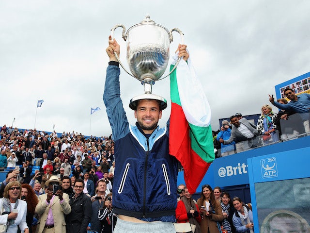 Bulgaria's Grigor Dimitrov celebrates with the winners trophy after clinching victory in the AEGON Championships at Queen's Club on June 15, 2014