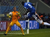 Italy's forward Mario Balotelli heads the ball to score a goal as England's goalkeeper Joe Hart (L) and England's defender Gary Cahill try to defend during a Group D football match between England and Italy at the Amazonia Arena in Manaus during the 2014 