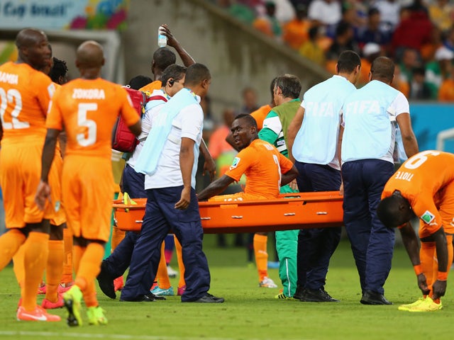 Arthur Boka of the Ivory Coast is carried off the field during the 2014 FIFA World Cup Brazil Group C match between the Ivory Coast and Japan at Arena Pernambuco on June 14, 2014