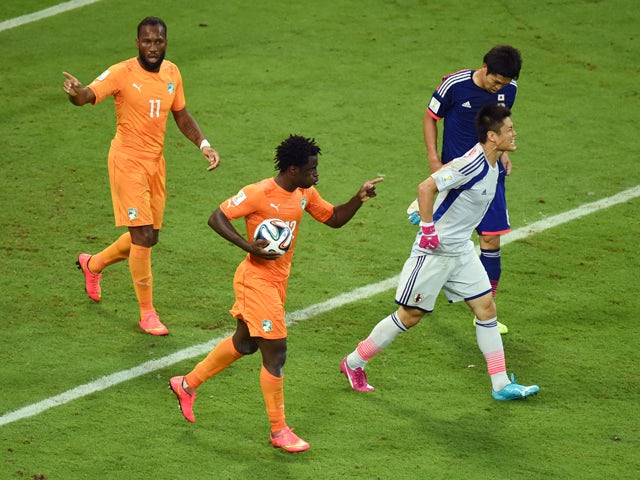 Wilfried Bony of the Ivory Coast celebrates scoring his team's first goal with Didier Drogba as goalkeeper Eiji Kawashima of Japan reacts during the 2014 FIFA World Cup Brazil Group C match between the Ivory Coast and Japan at Arena Pernambuco on June