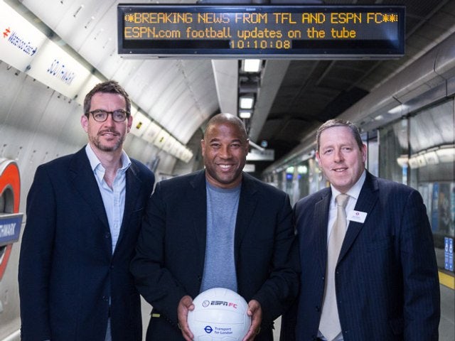 John Barnes poses on the on the London Underground with tube officials on June 10, 2014.