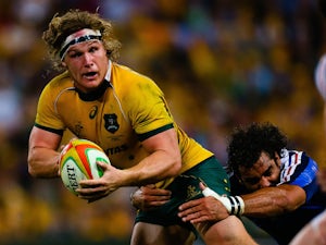 Australian flanker Michael Hooper is tackled by French wing Yoann Huget during the first rugby union test match against France at Suncorp Stadium in Brisbane on June 7, 2014