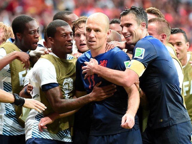 Netherlands' forward Arjen Robben celebrates with his team-mates after scoring a goal during a Group B football match between Spain and the Netherlands at the Fonte Nova Arena in Salvador during the 2014 FIFA World Cup on June 13, 2014