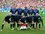 Netherlands players  line up for a photo before a Group B football match between Spain and the Netherlands at the Fonte Nova Arena in Salvador during the 2014 FIFA World Cup on June 13, 2014