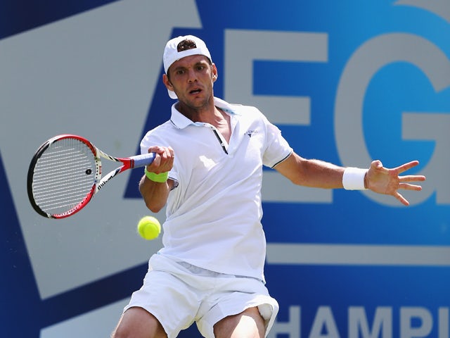 Paul-Henri Mathieu of France plays a forehand shot against Aljaz Bedene of Slovenia during their first round match on day one of the Aegon Championships at Queens Club on June 9, 2014