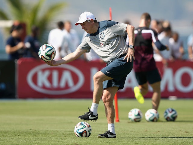 England manager Roy Hodgson bends down during a training session in Rio de Janeiro on June 9, 2014