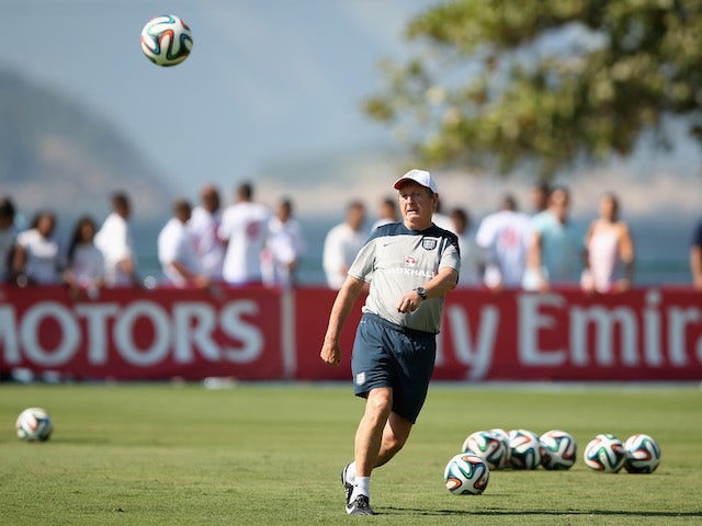 England manager Roy Hodgson kicks a football during a training session in Rio de Janeiro on June 9, 2014