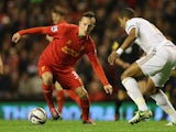 Samed Yesil of Liverpool competes with Ashley Williams of Swansea City during the Capital One Cup Fourth Round match between Liverpool and Swansea City at Anfield on October 31, 2012
