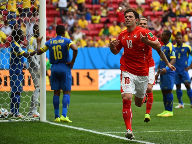 Switzerland's forward Admir Mehmedi celebrates after scoring during a Group E football match between Switzerland and Ecuador at the Mane Garrincha National Stadium in Brasilia during the 2014 FIFA World Cup on June 15, 2014