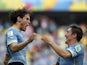 Uruguay's forward Edinson Cavani celebrates with his teammate Uruguay's midfielder Cristian Rodriguez after scoring during a Group D football match between Uruguay and Costa Rica at the Castelao Stadium in Fortaleza during the 2014 FIFA World Cup on June 