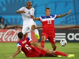 Andre Ayew of Ghana shoots and scores his team's first goal past John Brooks and Fabian Johnson of the United States (R) during the 2014 FIFA World Cup Brazil Group G match on June 17, 2014