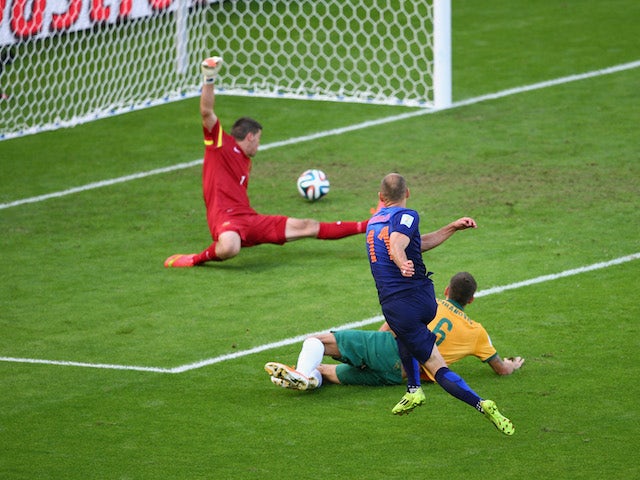 Netherlands winger Arjen Robben scores the first goal of the World Cup Group B match against Australia in Porto Alegre on June 18, 2014