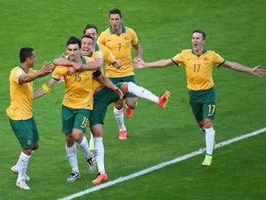 Mile Jedinak of Australia celebrates scoring his team's second goal with teammates during the 2014 FIFA World Cup Brazil Group B match between Australia and Netherlands at Estadio Beira-Rio on June 18, 2014