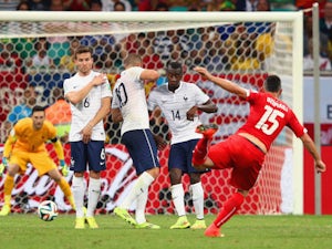 Blerim Dzemaili of Switzerland shoots and scores his team's first goal against France on June 20, 2014